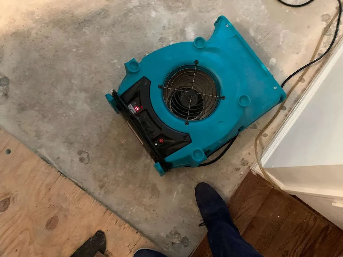 Air mover drying subfloor during Leak Detection & Repair in Johnson Lane